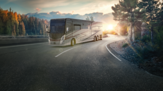 An RV driving on a curved road showcasing Wynne windows.